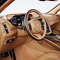 Aston Martin Red SUV Exterior Featuring Brown Leather Interior And Steering Wheel