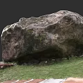 Natural Large Stone Rock With Rough Texture On Green Grass Ground Surface