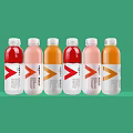 Six Various Colored Bottled Drinks With White Labels And Red Orange Logos On Green Background