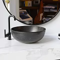 Modern Black Oval Stone Bathtub on Gray Stone Platform with Black Faucet
