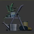 Green Plants in Decorative Flower Pots on Metal Folding Chair with Watering Can