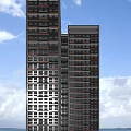 Modern High Rise Residential Building With Multiple Windows And Blue Sky Background