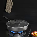 Stainless Steel Frying Pan on Gas Stove with Blue Flame and Hanging Checkered Towel