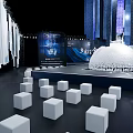 Modern Conference Hall Featuring White Cube Seats Central Spherical Installation And Blue Decorations