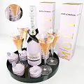 Pink And White Striped Frosted Cupcakes On Black Tray With Moet Champagne Bottle And Flutes