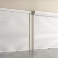 White Roller Shutters Installed On Light Wall With Smooth Gray Floor