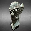 Ancient Bronze Mask Sculpture With Unique Facial Features And Ear Design