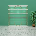 Modern Display Shelf With Golden Frame Against Green Wall And Potted Plant On Terrazzo Floor