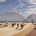 Scenic Waterfront Landscape With Arched Structures Palm Trees And Public Leisure Activities