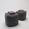 Gray Fabric Ottomans With Purple Cover Books Placed On Top For Home Decor