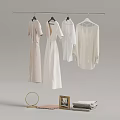 Collection of White and Light Clothes Hanging on Hangers with Decorative Mirror Frame and Towel