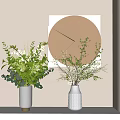 White Decorative Vases With Green Foliage And White Blossoms Near Modern Geometric Wall Art