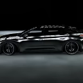 Sleek Black Modern Car Driving On Road With Aerodynamic Body And Sporty Wheels