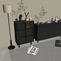 Gray Chest of Drawers with Green Plants Rabbit Figurine and Floor Lamp on Striped Rug