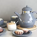 Gray Ceramic Teapot And Gold Rimmed Coffee Cups With Plates Croissants And Pastries