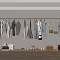 Various Clothes Hanging On Rail In Wardrobe Area With Bags Shoes Bookshelf And Boxes