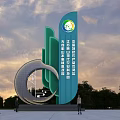 Modern Spiritual Fortress Sculpture In Green With Circular Elements And People Near Trees