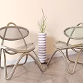 Two Transparent Leisure Chairs With Metal Frame White Layered Vase And Green Plant
