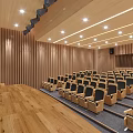 Modern Conference Room With Rows Of Seats And Large Screen