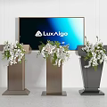 Three Modern Podiums With LuxAlgo Screen And Decorative Flower Arrangements