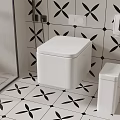 White Toilet in Modern Bathroom with Black Floral Tile and White Trash Bin Accessories