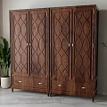 Dark Brown Wooden Wardrobe with Carved Patterns Four Doors Drawers and Indoor Potted Plant