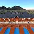 Red Guesthouse Building with Black Roof Wooden Boardwalk Blue Pools Surrounding Trees and Distant Mountains