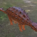 Detailed Reptile Dinosaur Model With Spiked Back And Spotted Skin In Forest Grassland