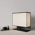 Modern Pendant Light with Minimalist Design and Fabric Shade on Table with Vintage Camera