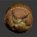 Golden Brown Poppy Seed Muffin In Paper Liner With Cracked Top
