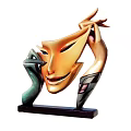Abstract Sculpture With Orange Mask Face Green Hands And Black Base