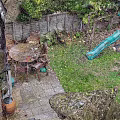 Outdoor Garden Landscape With Wooden Table Chairs Green Slide And Lush Grass