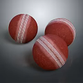 Three Red Cricket Balls With White Stitching On Dark Background