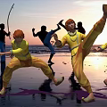 Men In Yellow Clothing Practicing Martial Arts On Seaside Beach During Sunset