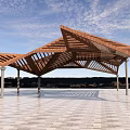Outdoor Modern Wooden Pergola With Geometric Open Roof Supported By Columns On Paved Floor