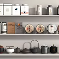 Traditional Teaware Collection With Tea Canisters And Cakes On Display Shelves