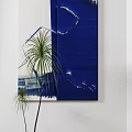 Blue Abstract Painting With Brush Strokes And Green Palm Plant On White Wall