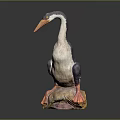 Gray And White Bird Sculpture With Orange Beak Feet On Colorful Rock Base