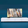 White TV Stand With Storage Drawers Holding Flat Screen TV And Speakers