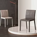 Modern Light And Dark Upholstered Single Chairs With Sleek Design On White Display Platform