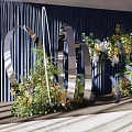 Modern Banquet Hall With Dark Blue Curtains And Metal Circular Floral Decorations