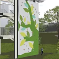 Outdoor Sports Equipment Climbing Wall With Painted Leaf Patterns On Tower Surrounded By Green Trees And Grass