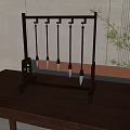 Traditional Chinese Calligraphy Brushes on Dark Wooden Rack with Brown Table and Green Plant