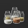 Multiple Clear Glass Spice Jars Containing Different Seasonings For Kitchen Use