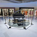 Showcase Shelf In Shopping Mall Featuring Black Piano On Circular Platform With Shiny Floor