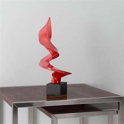 Red Spiral Sculpture With Black Base On Wooden Table And White Background 3d model