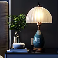 Stylish Single Sofa in Bedroom with White Shade Blue Base Lamp Green Plant and Books