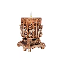 Decorative Carved Candle Holder With Lit Candle And Intricate Ornate Patterns