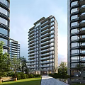 Modern High Rise Residential Building With Glass Curtain Walls Balconies And Greenery