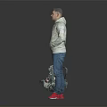 Man in Gray Hoodie Blue Jeans Red Shoes Holding Patterned Backpack Against Gray Black Background